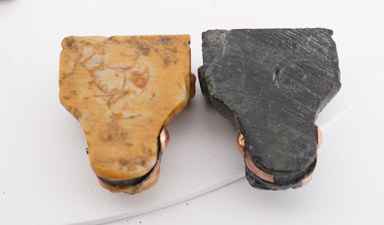 A collection of carved lava fragments, 19th century, once forming a bangle, the fragments variously carved with abstract floral motifs, lion's heads, and a theatrical mask, largest 6.2cm, Condition: fragmentary, but carv
